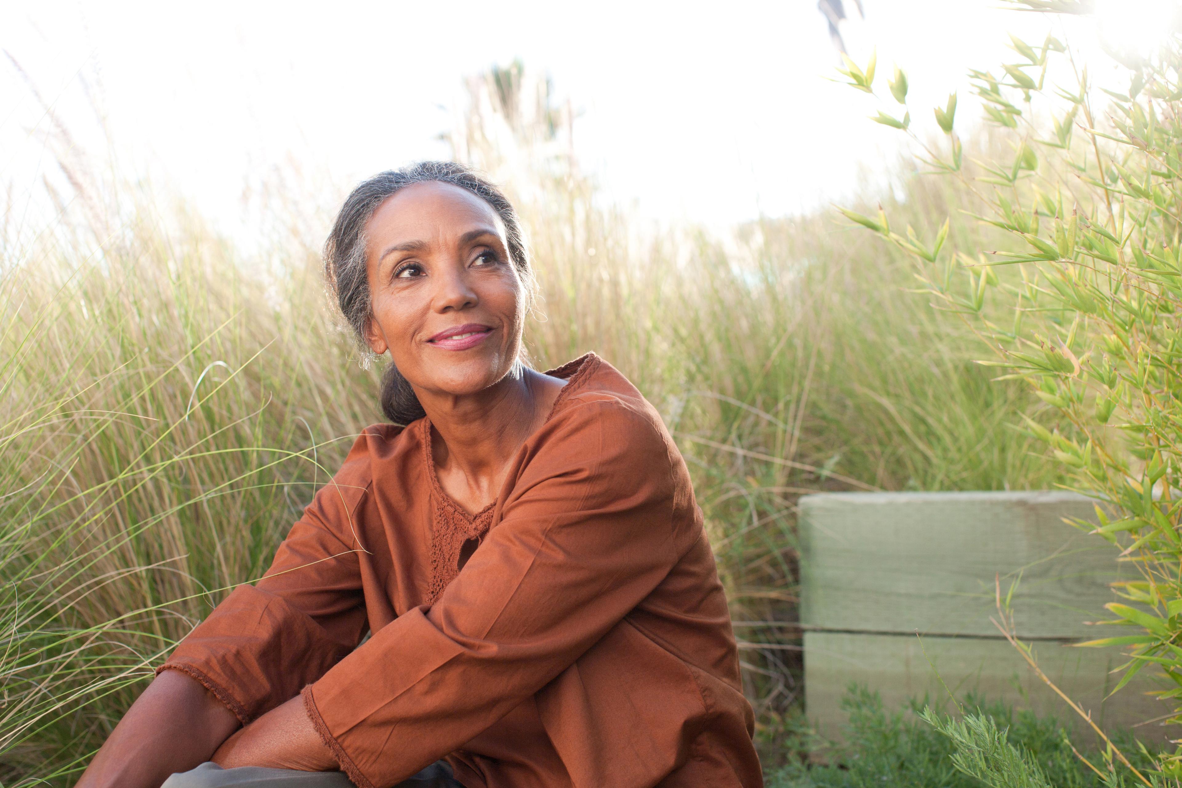 Person with eyes closed breathing deeply outdoors